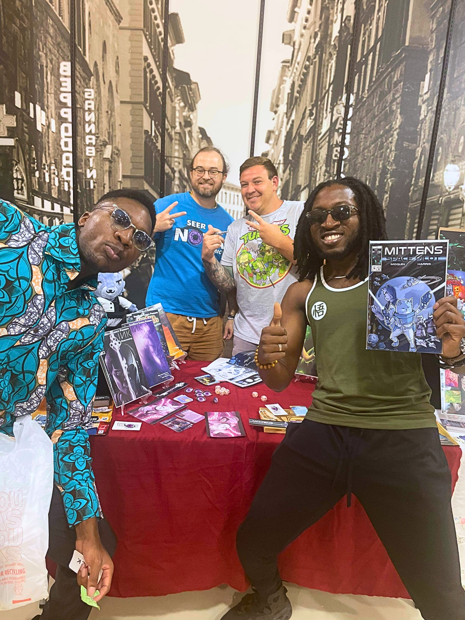 SeerNova Comics tabling at Forever Con '23 with two fans showcasing the comic book Mittens